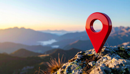 Glossy red location marker above dramatic mountain peaks at sunrise, misty valleys below