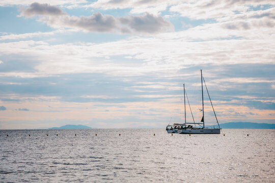 Ship at sea, the sea is calm, the picture is taken at the golden hour. A picture that radiates warmth. On the shores of Greece.
