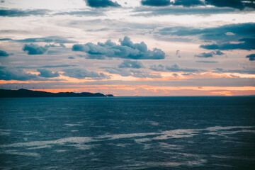 The sky with clouds after sunset. The clear horizon line between the sky and the sea. Greek shore, sunset.