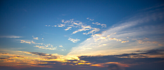 Beautiful sunset sky background with tiny clouds. Panoramic view.