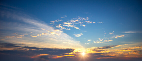 Beautiful sunset sky background with tiny clouds. Panoramic view.