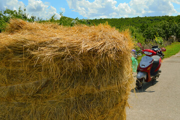 A haystack and a moped on a village road