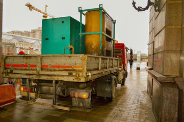 The truck is loaded with green and yellow containers.