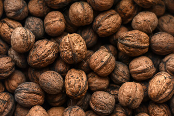 Walnuts texture. A lot of walnuts. Healthy organic food concept. Blurred photo for background.Brown...