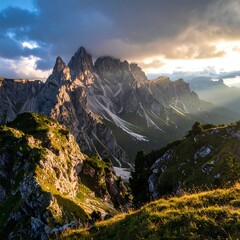 Dramatic mountain range under a cloudy sky with sun rays