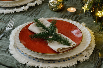Christmas table setting. Celebratory crockery is adorned for Christmas feast