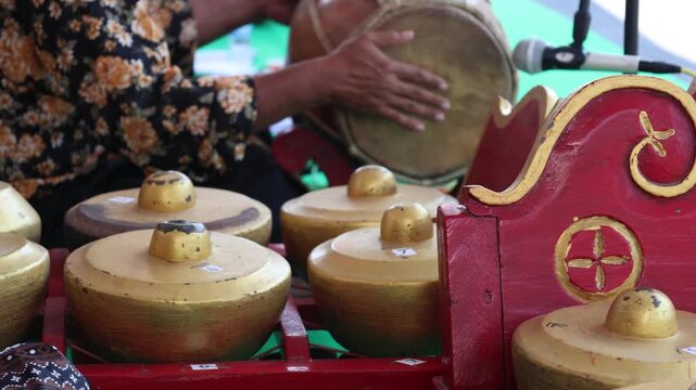 Indonesians are playing one of the traditional instruments from Java. Gamelan Musician Plays, Traditional Instruments. 
