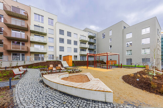 Modern courtyard garden with playground and seating area in urban apartment complex
