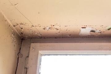 Old house with cracked wall and peeling paint