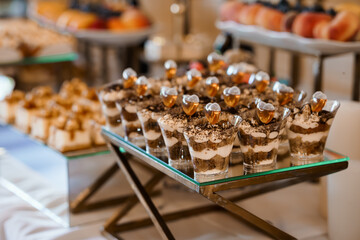 Elegant Chocolate Dessert Parfaits Display at Buffet. Rich Brown Tiramisu Cups, Glassware, Luxury Catering, Appetizers, Festive Celebration.