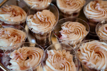 Elegant Chocolate Dessert Shooters with Swirled Frosting  Close-up Food Photography, Party Treats, Brown and Beige Tones, Rustic Style.