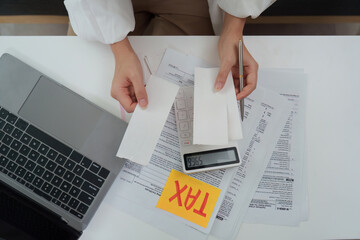 Tax documentation. Reviewing receipts and using a calculator for tax filing.