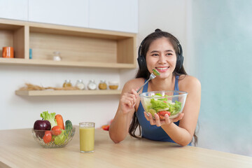 Food Wellness: Smiling woman enjoying fresh salad with a smoothie