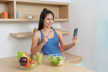Food Wellness: Young woman enjoying healthy salad while video calling