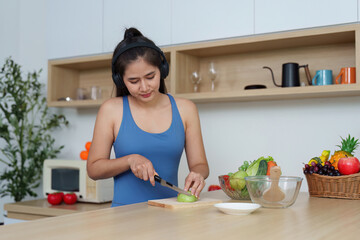 Food Wellness: Woman slicing green apple in a modern kitchen