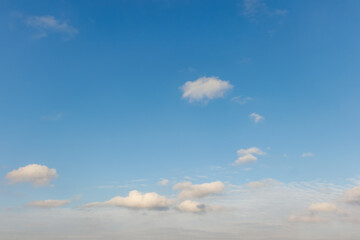 Soft clouds floating in a bright blue sky