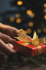 Man holding Christmas gift in hands