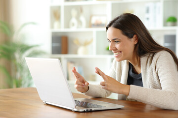 Hopeful woman is crossing fingers waiting online results
