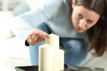 Obsessed woman aligning candles accurately