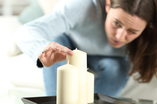 Obsessed woman aligning candles accurately
