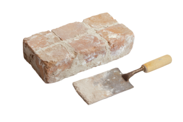 Bricklaying trowel resting on a stack of bricks isolated on transparent background. Brick with trowel and mortar isolated on white background.