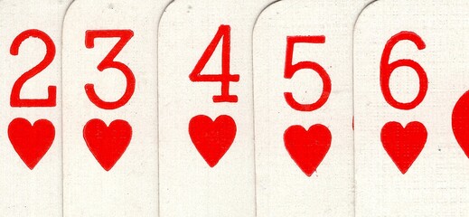 Close up detail from a poker hand of vintage playing cards.