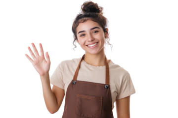 Young woman wearing an apron waving hello isolated on transparent background. Portrait of a happy young latin woman in a brown apron standing and waving her hand isolated on white background.