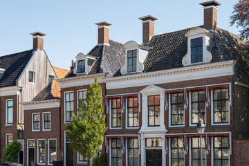 Facades of historic canal houses in the center of Harlingen in the Netherlands.