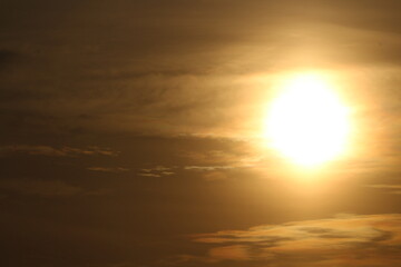 Golden sun in a clouds background wallpaper. Golden sunset in a clouds 