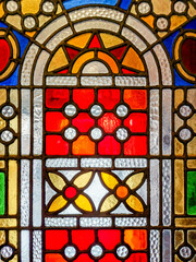 Stained glass with geometric shapes in a historic building