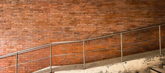 Brick wall with stairs and a metal railing in an urban setting