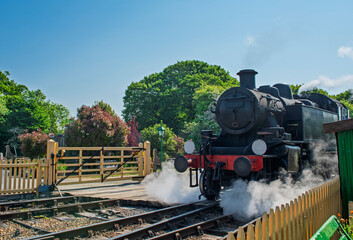 Old steam engine locomotive travelling over level crossing © Paul Vinten