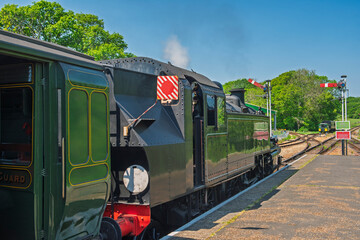 Old heritage steam locomotive railway engine at station platform