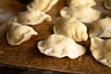 Raw Dough Dumplings on a Wooden Cutting Board