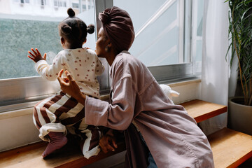 Mother and child looking outside