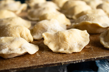 Raw Dough Dumplings on a Wooden Cutting Board