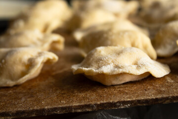 Raw Dough Dumplings on a Wooden Cutting Board
