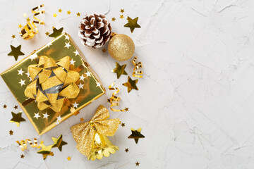 Golden gift boxes and decor on concrete background, top view