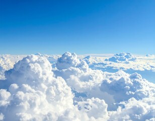 Aerial view of fluffy white cumulonimbus clouds against a bright blue sky