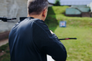 Crossbow shooting and archery at the shooting range, women and men practicing with arbalest at shooting gallery, compound bow training, aiming the target with arbalest at archery range, bow and arrows