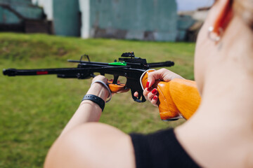Crossbow shooting and archery at the shooting range, women and men practicing with arbalest at...