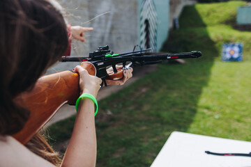 Crossbow shooting and archery at the shooting range, women and men practicing with arbalest at...