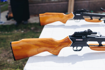 Crossbow shooting and archery at the shooting range, women and men practicing with arbalest at...