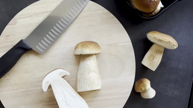 Top view of fresh boletus mushroom on wooden cutting board 