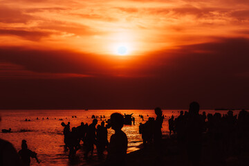 Sunset on the beach. People on the beach at sunset