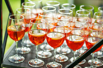 Glasses of Aperol spritz cocktail arranged on bar