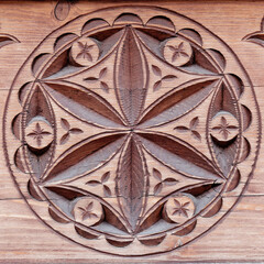 Carved wood architectonic detail of wall. Folklore decorative hexafoil motif. © Rita Paulina Kłysik