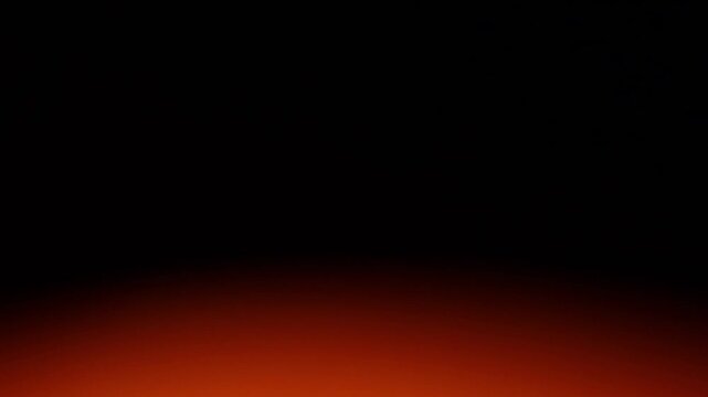 Una toma de cerca de un fondo abstracto de color anaranjado con negro  con un degradado ligero desenfocado en movimiento. 
