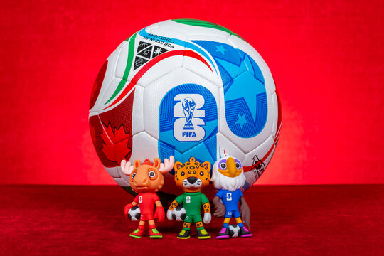 ZHONGSHAN China-October 20 2025: official mascots and the soccer for the 2026 FIFA World Cup on red at horizontal composition.