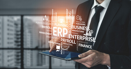 Business professional using digital tablet to access ERP software for enterprise resource planning and management in modern office environment. Tessel.